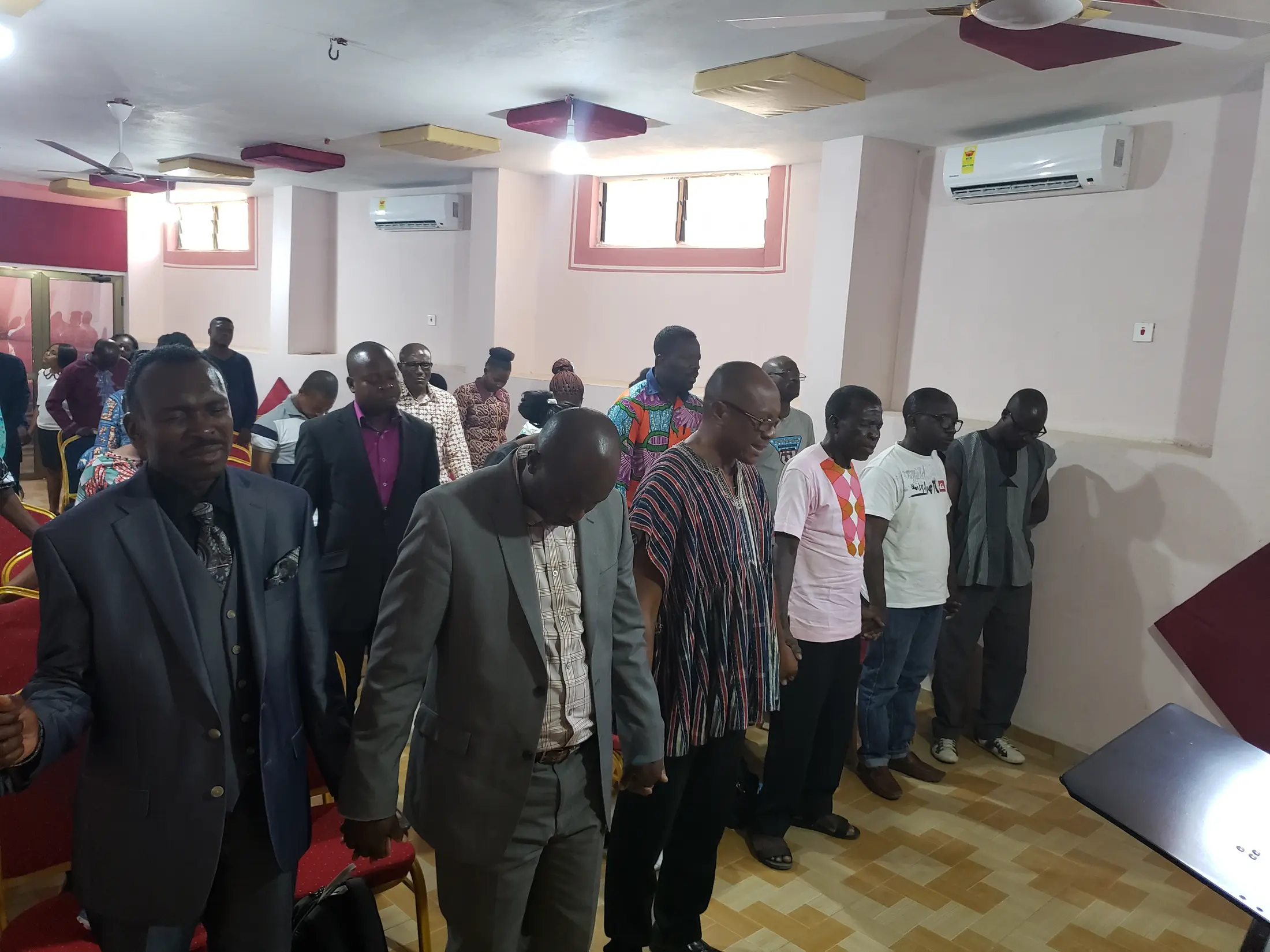 Church leaders gathered in prayer during a mission visit