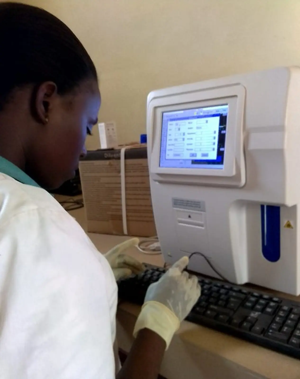 A local healthcare professional operating laboratory equipment