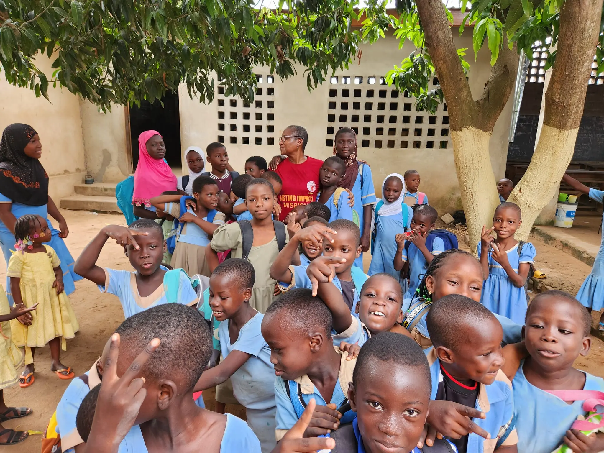 Students gathered with a mission volunteer during a school visit